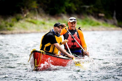 two people wearing life jacket rafting in rishikesh