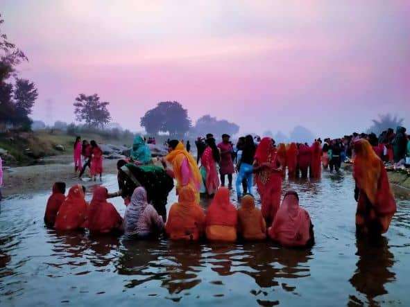 Devotees standing in water during Chath puja