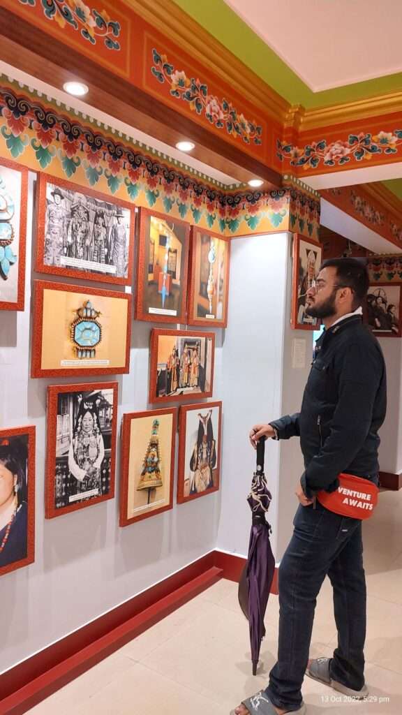 A man watching painting on the wall of a museum