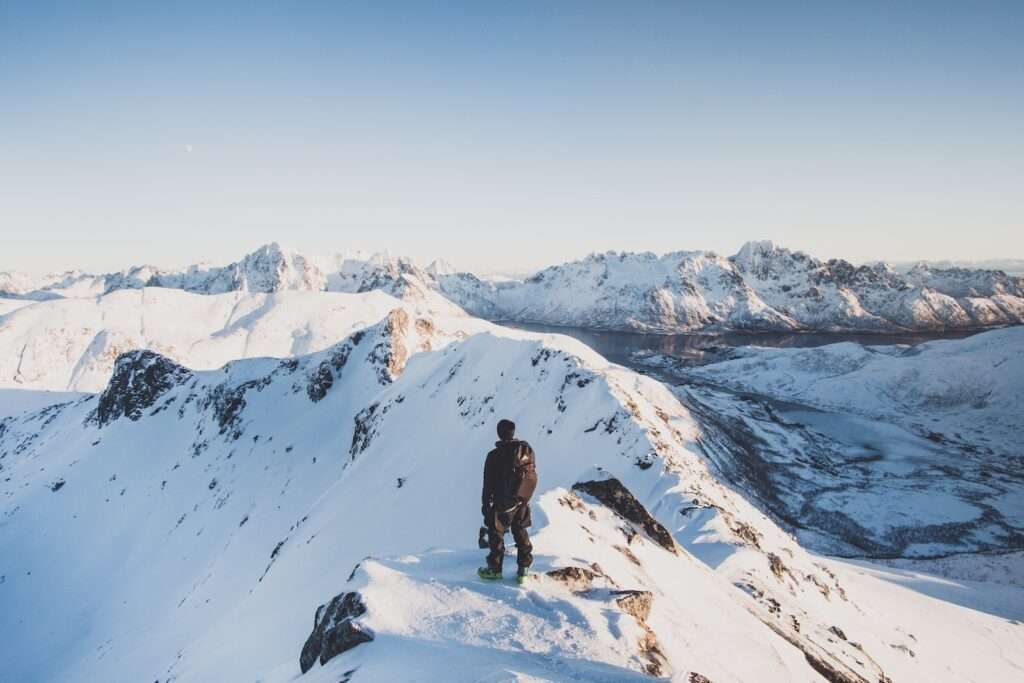 person swearing jackets and sweaters and boots in Manali in december