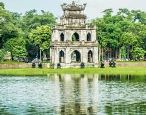 White building near water reservoir in Hanoi is a major tourist site and a milestone in Hanoi Tourism