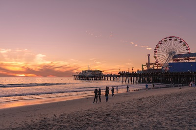 tourists walking towards the big wheel which is one of the best places to visit in California at beach side at sunset