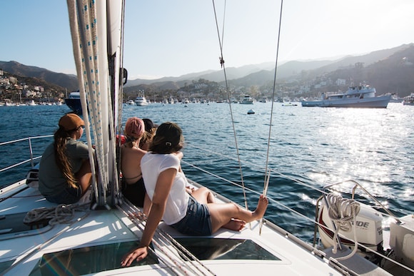 people sitting on front of yacht at catalina island in california during summer