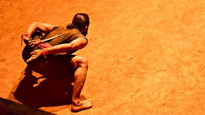 Man attacking his opponent with a knife in his back at show in Kalari Kshetra in Munnar