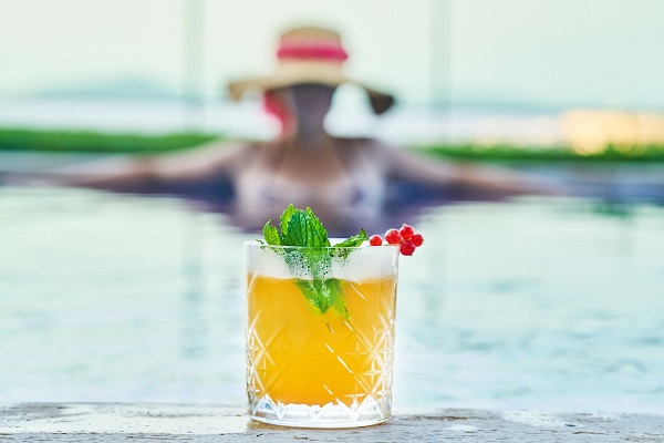 woman with a drink in a swimming pool